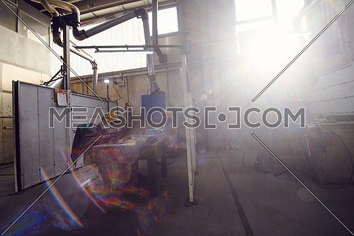 Metal industry worker working in a factory, wearing a protective face mask during coronavirus or covid19 pandemic. High quality photo