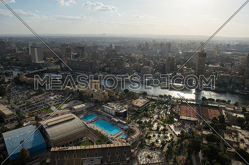 aerial view of modern Greater Cairo city downtown with Nile and pyramids in the horizon on a beautiful sunny day with blue sky and clouds capital of Egypt