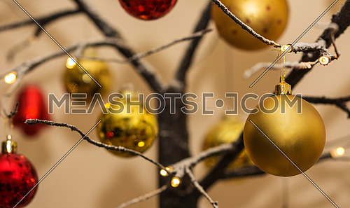 Christmas decorations hanging from contemporary christmas tree