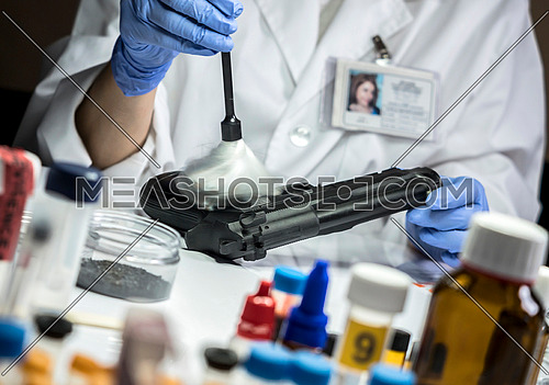 Police Scientific extracts traces of a gun in the laboratory of balistica, conceptual image
