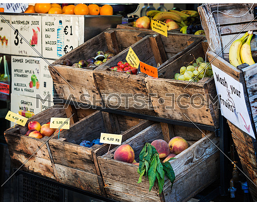 In the photo an old fruit shop in the center of Florence, where the fruit is exposed still in old wooden crates