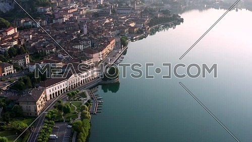 Drone view of Lake Iseo at sunrise, on the left the city of Lovere which runs along the lake,Bergamo Italy.