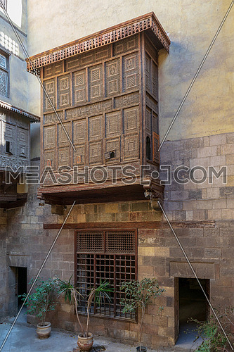 Facade of Zeinab Khatoun historic house with Mamluk era style oriel window covered by interleaved wooden grid (Mashrabiya), located near to Al-Azhar Mosque in Darb Al-Ahmar district, Old Cairo, Egypt
