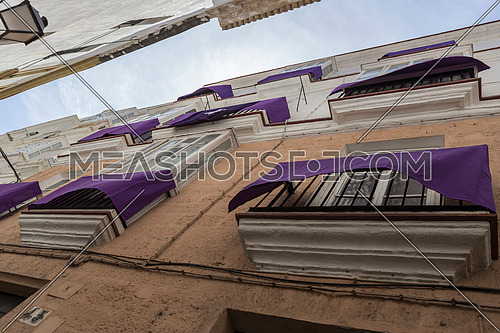Cadiz Spain- March 31: Detail of balconies and large windows on the time of the nineteenth century, Narrow street with traditional architecture in Cadiz, Andalusia, southern Spain