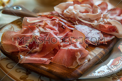 Typical various italian salami, servided on plate at restaurant.