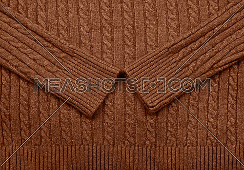 Close up background texture of brown cable knitted wool jersey fabric sweater with row braid pattern