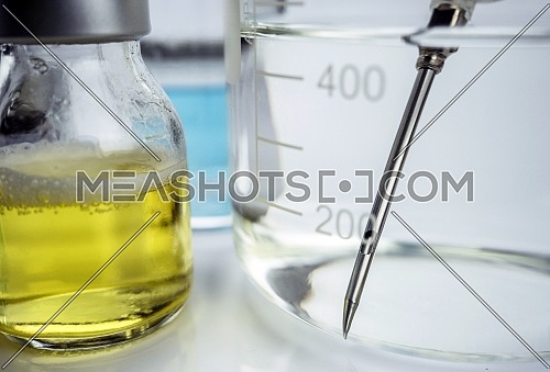 Needle inside precipitation glass along with roads in a hospital, conceptual image