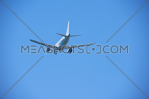 modern airplane travel,  clear blue sky in background