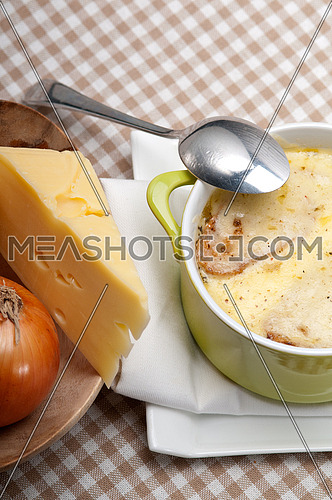 onion soup on clay pot with melted cheese and bread on top
