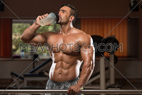 Muscular Man Drinking A Water Bottle