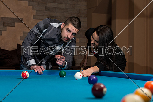 Young Caucasian Woman Receiving Advice On Shooting Pool Ball While Playing Billiards