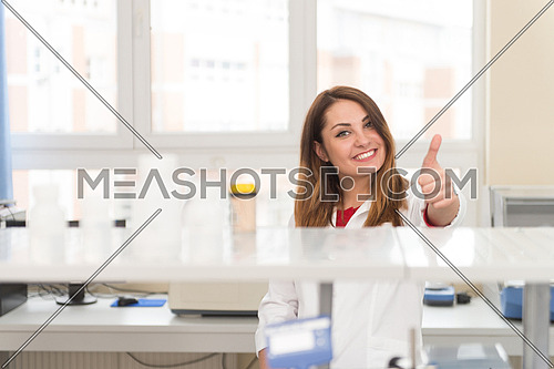 Portrait Of A Woman Student In A Chemistry Lab Smiling And Looking In The Camera