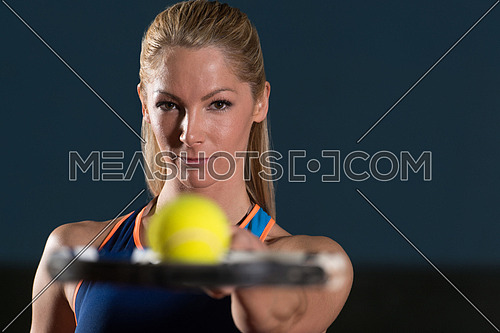 Close-up On Female Tennis Player Holding Racket With Ball