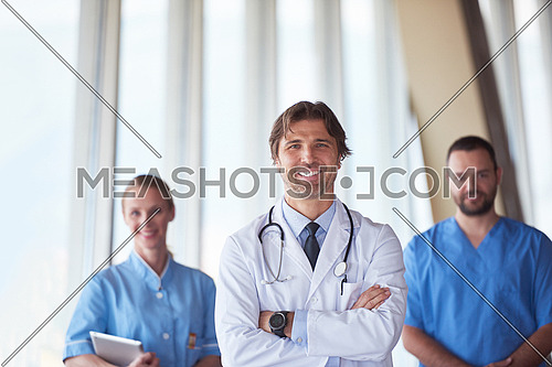 group of medical staff at hospital, handsome doctor in front of team, people group  standing together in background
