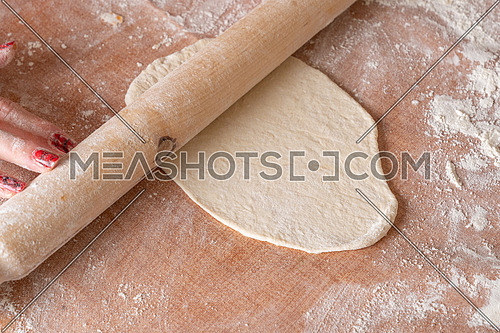 Making dough on brown table background,view from above.
