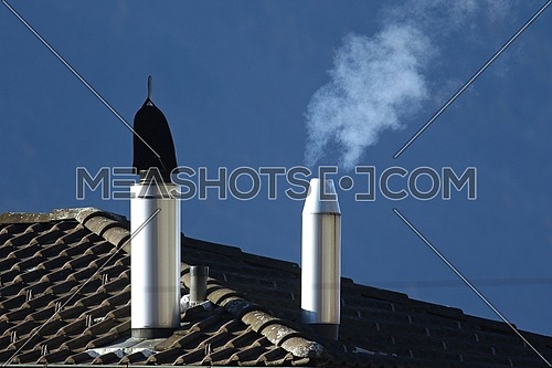 Heating oil going into the air from a filtered stack on a roof