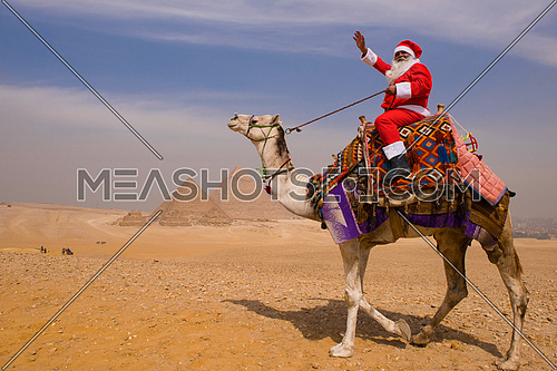 santa claus riding a camel in pyramids desert in Egypt Christmas concept