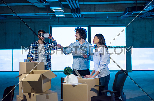 young team of business people in group, architect and engineer on construction site checking documents and business workflow using the virtual reality headset and laptop computer in new startup office