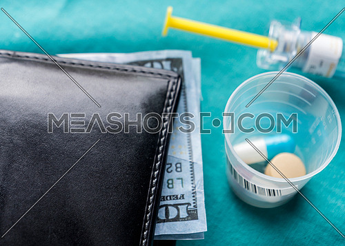 Wallet with dollar next to medicines, concept of copayment health