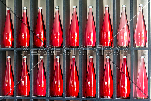 abstract background of decorative bottles of red juice in modern restaurant