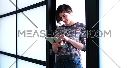 Pretty Businesswoman Using Tablet In front of Office Interior