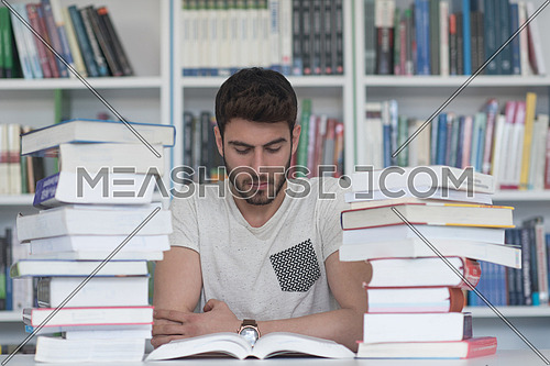Student reading book in school library. Study lessons for exam. Hard worker and persistance concept.