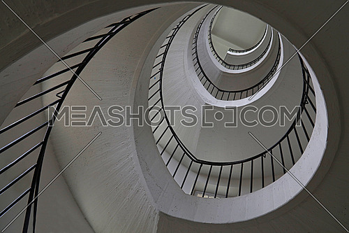 Spiral staircase with curve shape diminishing perspective, low angle view