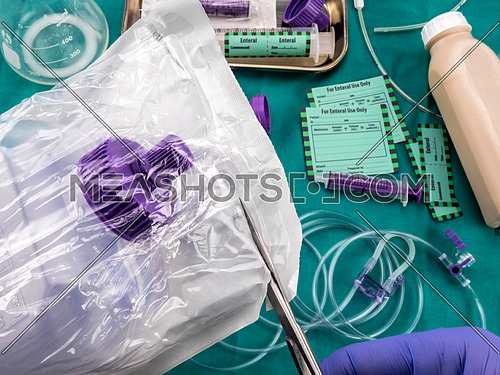 Nurse opening a bottle of enteral nutrition, palliative care in hospital, conceptual image, composition hotizontal