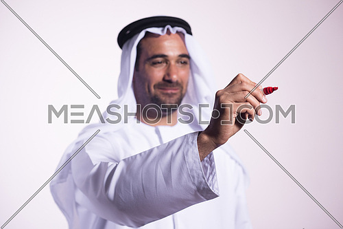 Arabian middle eastern business man writing with  marker on virtual screen
isolated on white