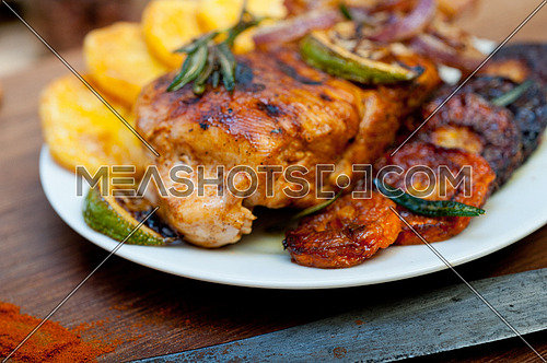 roasted grilled BBQ chicken breast with herbs and spices rustic style