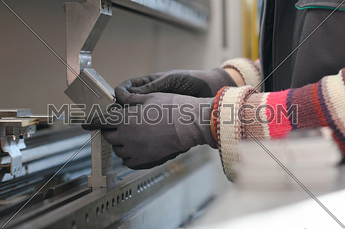 woman working in a modern factory and preparing material for a CNC machine. . High quality photo