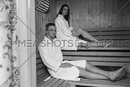 Portrait of a young happy beautiful couple enjoys relaxing in the sauna