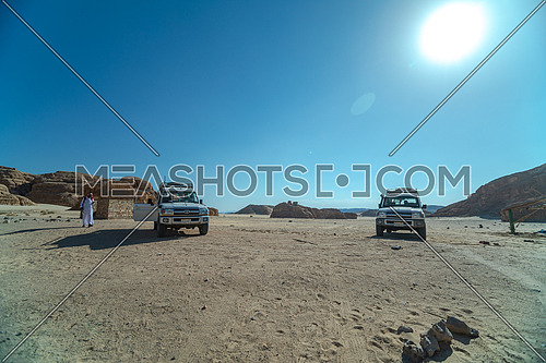 Two cars in the desert in Sinai at day.