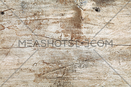 Grunge background texture of white painted wood with dark brown and black dirty stains, scratches and cracks