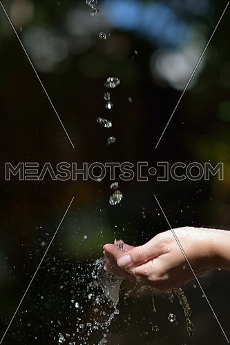 beauty and spa fresh water stream on woman hand