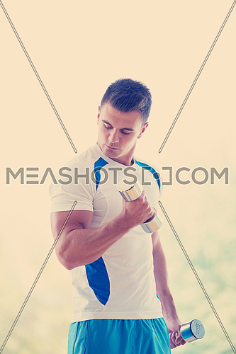 young man in fintess sport club exercise with weights and relaxing