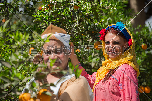 an egyptian farmer and his daughter posing in the farm