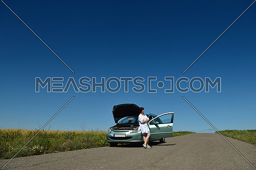 portrait of young beautiful woman with broken car outdoor