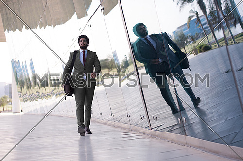 handsome middle eastern business man walking