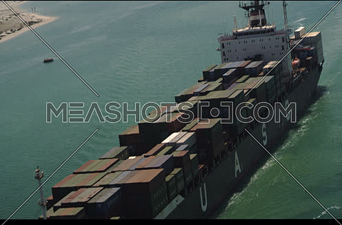 Arial shot for Cargo Ship sailing in Suez Canal at day