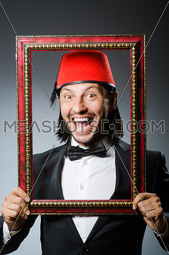 Man with fez  hat and picture frame