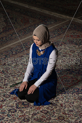 Humble Muslim Woman Is Praying In The Mosque