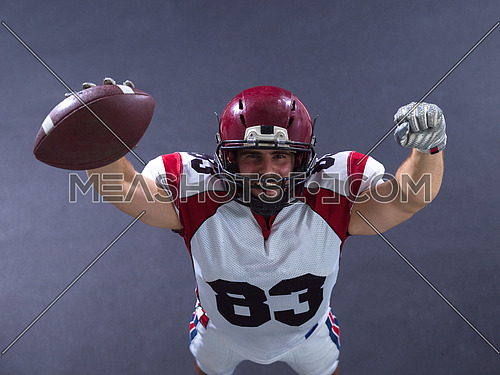 american football player celebrating touchdown isolated on gray background