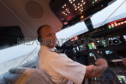 Portrait of a young middle eastern successful pilot in the cockpit