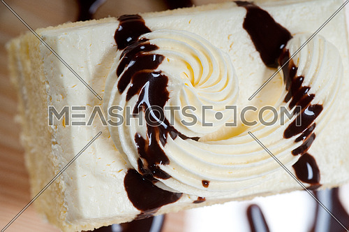 fresh cream cake closeup with chocolate sauce topping