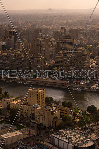 aerial view of modern Cairo city downtown with Nile and pyramids in the distance at beautiful sunny day with blue sky and clouds capital of Egypt
