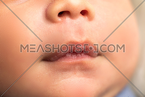 Nose, mouth, cheeks and chin or a newborn baby boy