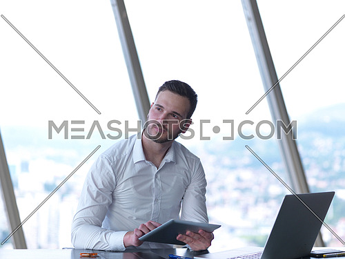 happy young business man work and relax at modern bright office interior, hipster with beard at workplace