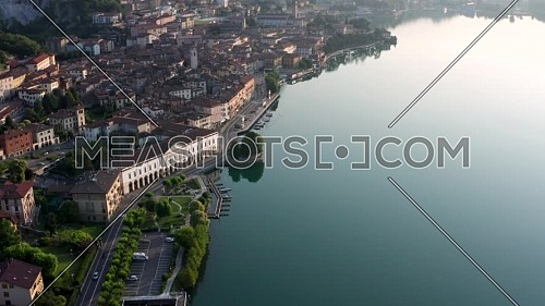 Drone view of Lake Iseo at sunrise, on the left the city of Lovere which runs along the lake,Bergamo Italy.