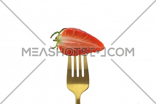 Half-cut strawberry on a golden fork isolated on a white background